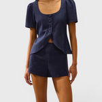 JONES + CO navy linen vest with scoop neckline, button front, and cap sleeves worn with matching shorts