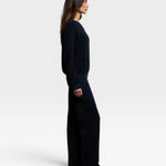 JONES + CO Ziggy sweatshirt in navy worn by a model in a side profile view with matching wide-leg trousers