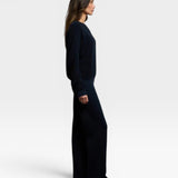 JONES + CO Ziggy sweatshirt in navy worn by a model in a side profile view with matching wide-leg trousers
