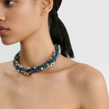 JONES + CO Nerium Necklace with rhinestones, seed beads, and floral beads in blue, green, and pink. Tubular roll shape with adjustable chain.