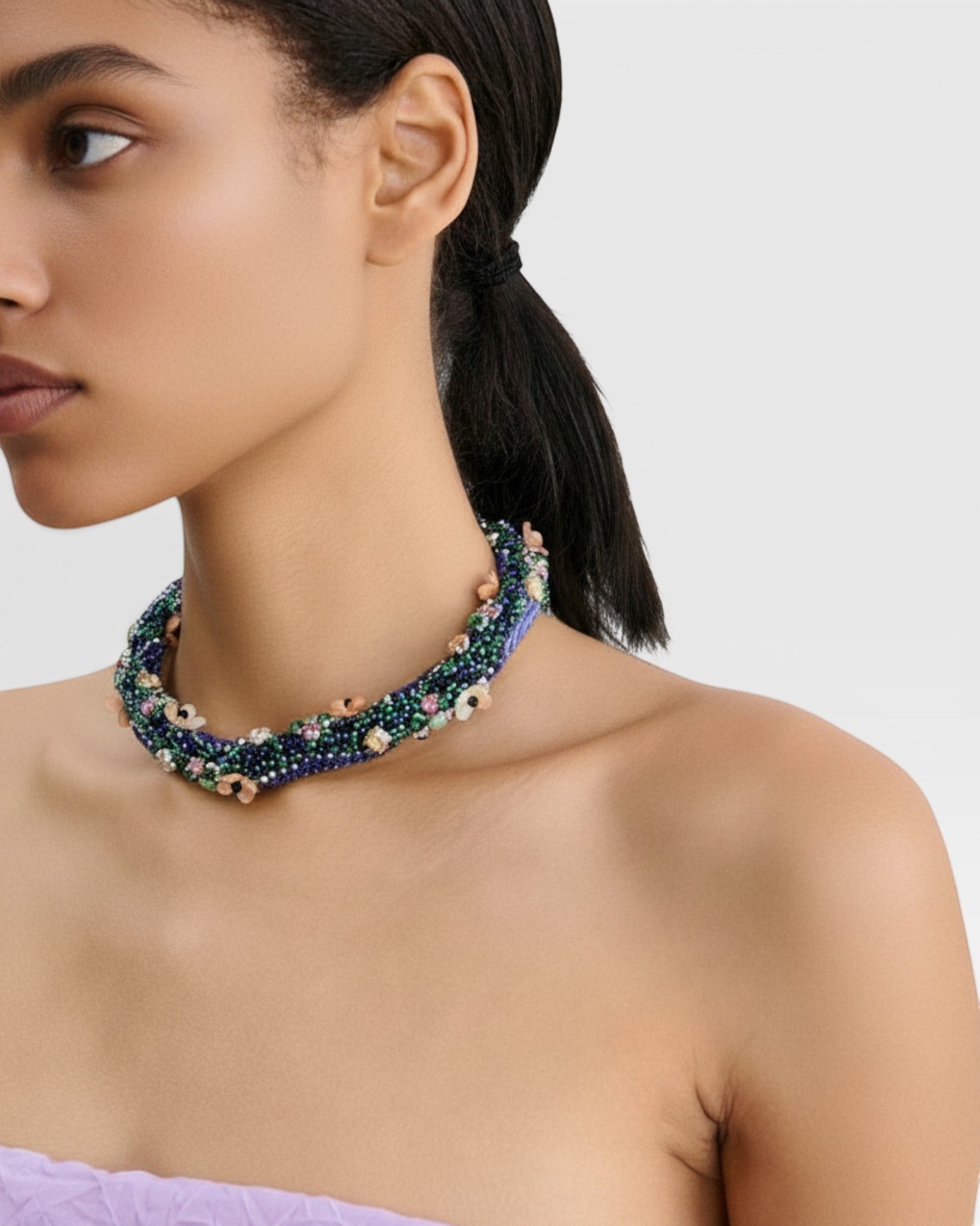 JONES + CO Nerium Necklace with rhinestones, seed beads, and floral beads in blue, green, and pink. Tubular roll shape with adjustable chain.