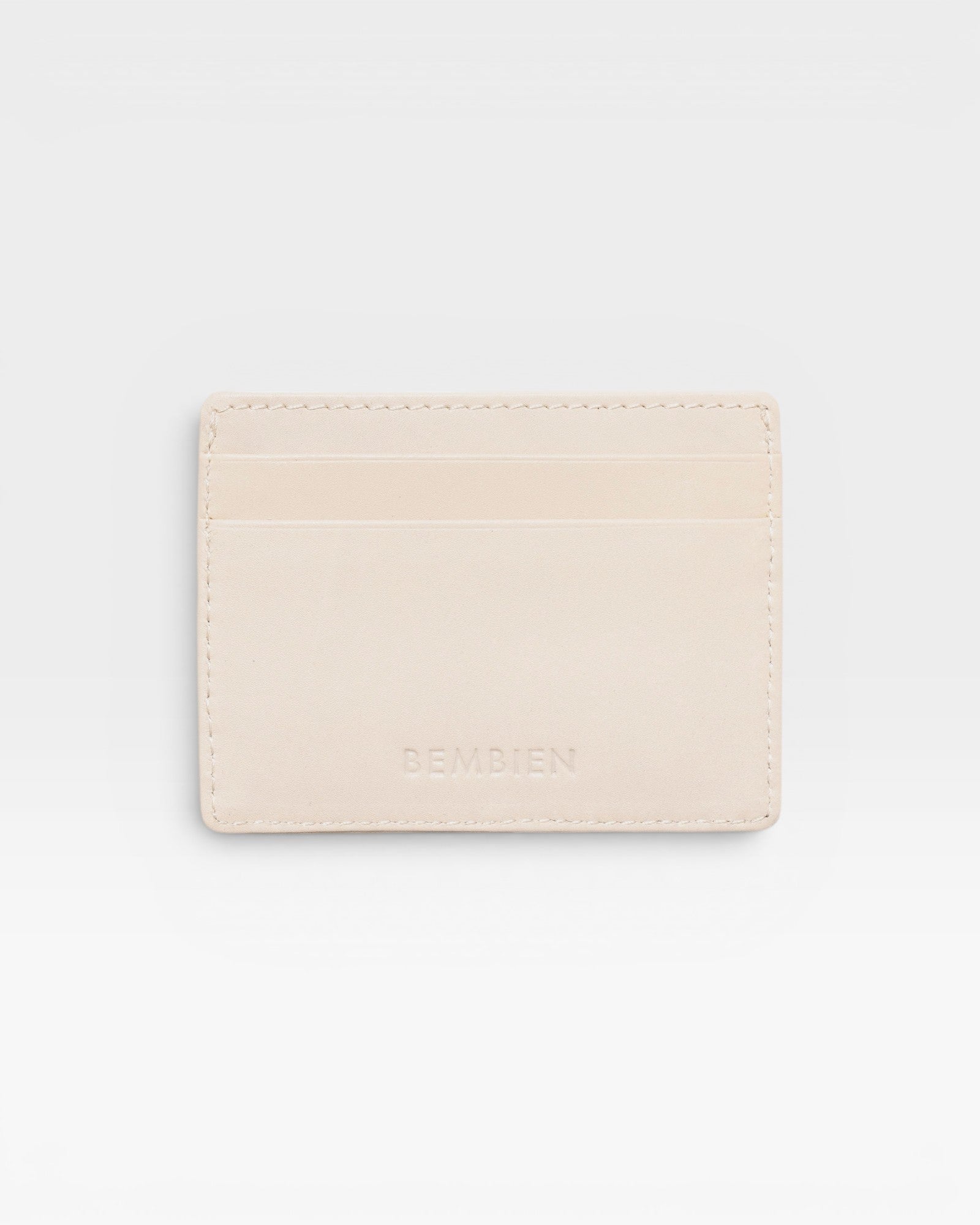 JONES + CO Nico card case in cream leather with two card slots and a central pocket.