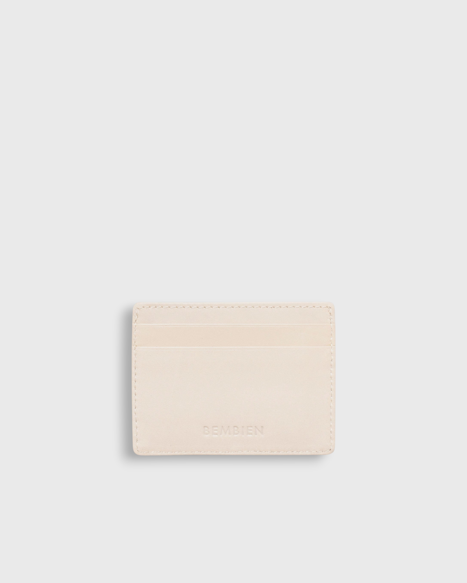 JONES + CO Nico card case in cream leather with two card slots and a central pocket.