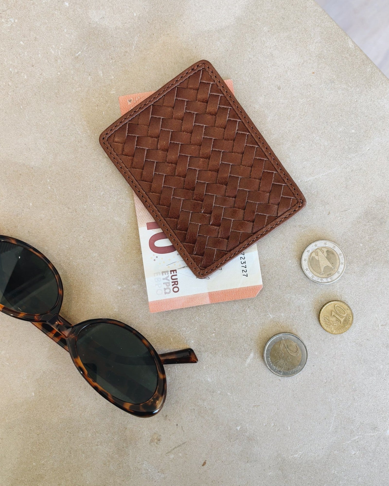 JONES + CO Nico Card Case in sienna brown handwoven leather with two card slots and bill pocket. Includes euro bills and coins.
