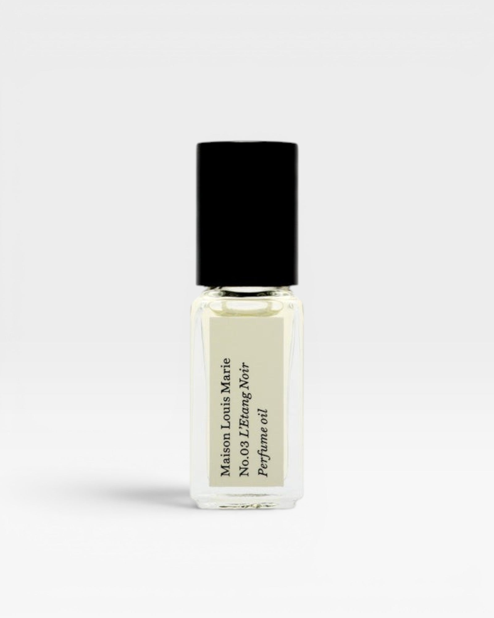 JONES + CO No.03 L'Etang Noir Perfume Oil travel size glass bottle with black cap and cream label.