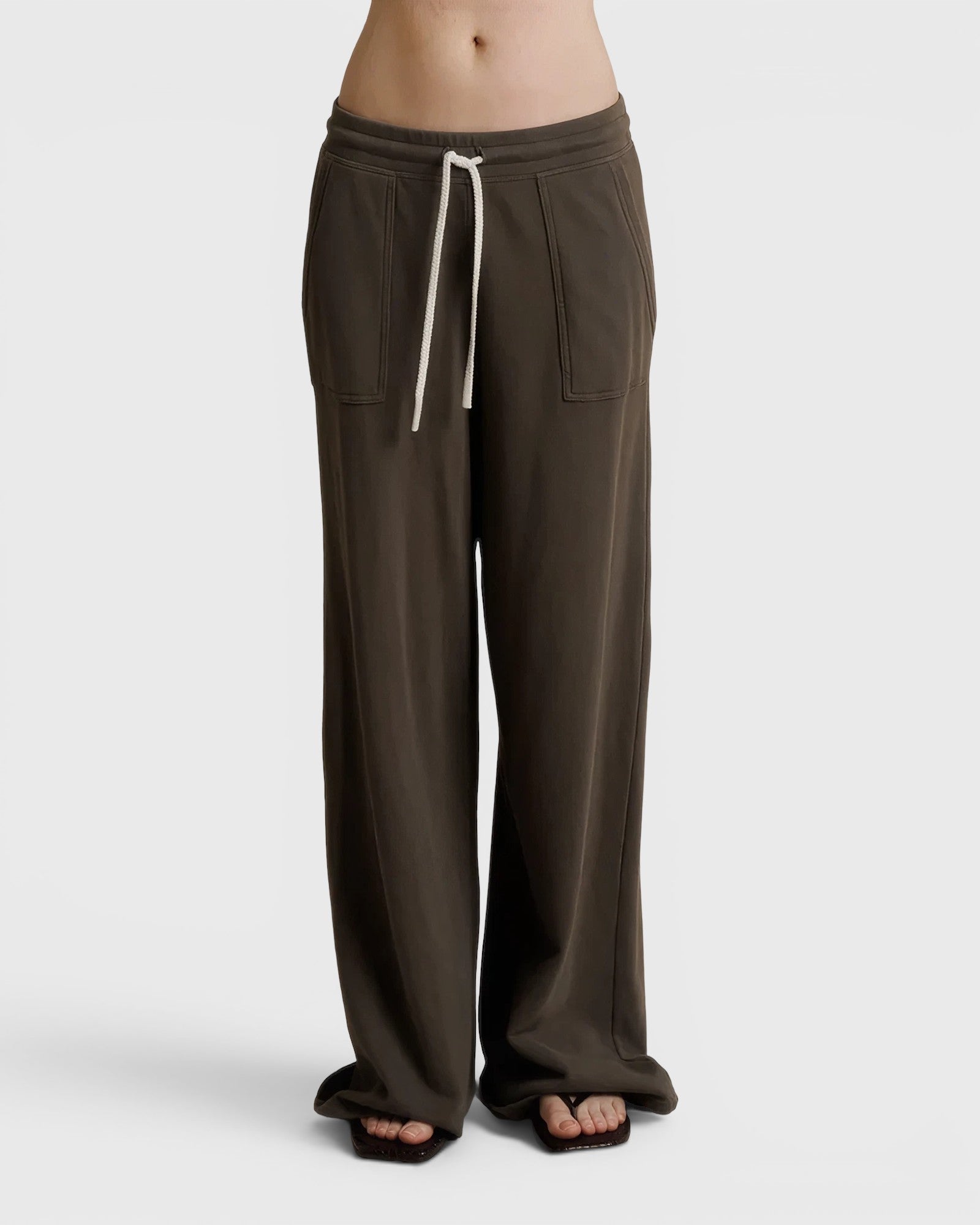 JONES + CO Noa straight-leg french terry pants in dark olive with a rope drawstring waist and deep side pockets.