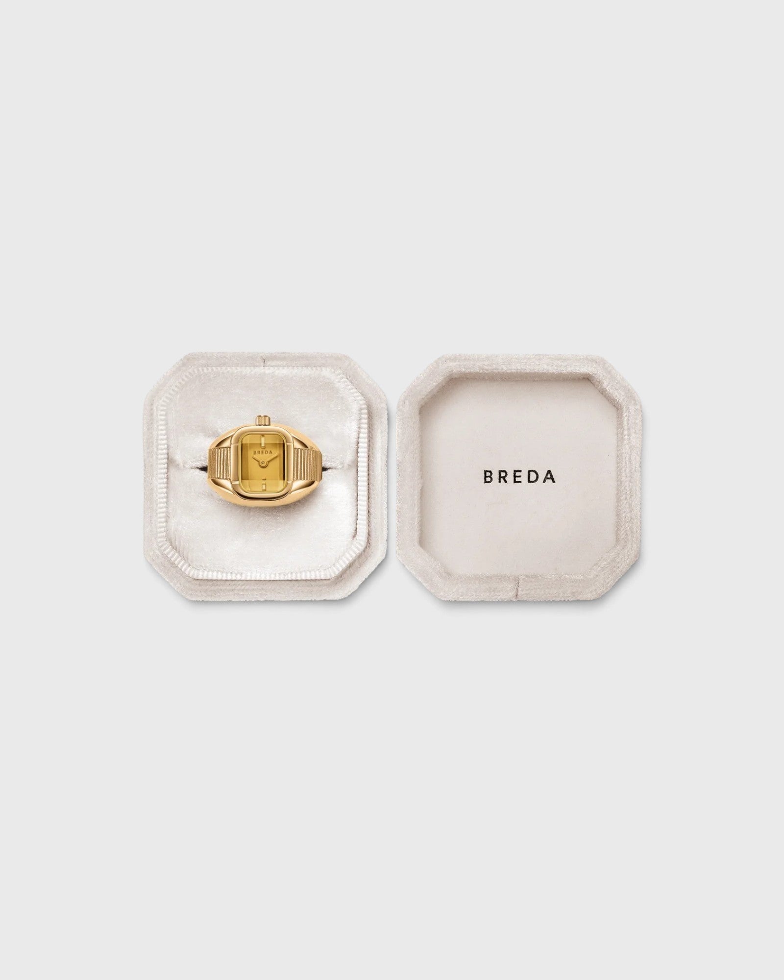 JONES + CO Nocturne Time Ring in 18K gold-plated stainless steel with an amber crystal face in a velvet display box.