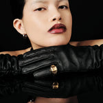 JONES + CO Nocturne Time Ring in 18K gold-plated stainless steel with amber crystal on a model wearing black gloves.