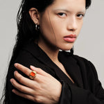 JONES + CO Nocturne Time Ring in 18K deep gold-plated stainless steel with a flame-colored crystal on a model