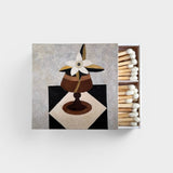 JONES + CO Nue matchbox featuring a decorative floral still life illustration with white-tipped wooden matches.