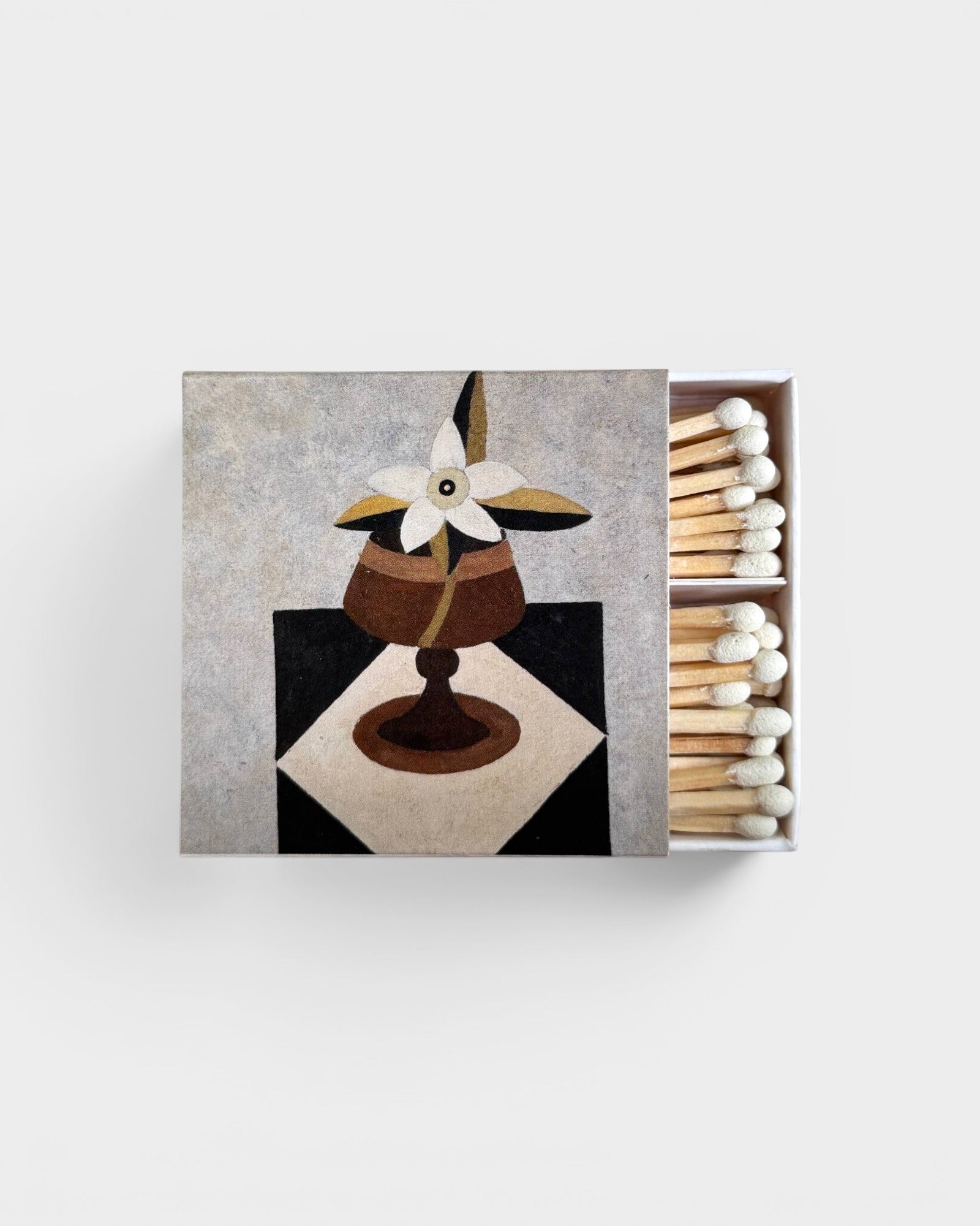 JONES + CO Nue matchbox featuring a decorative floral still life illustration with white-tipped wooden matches.