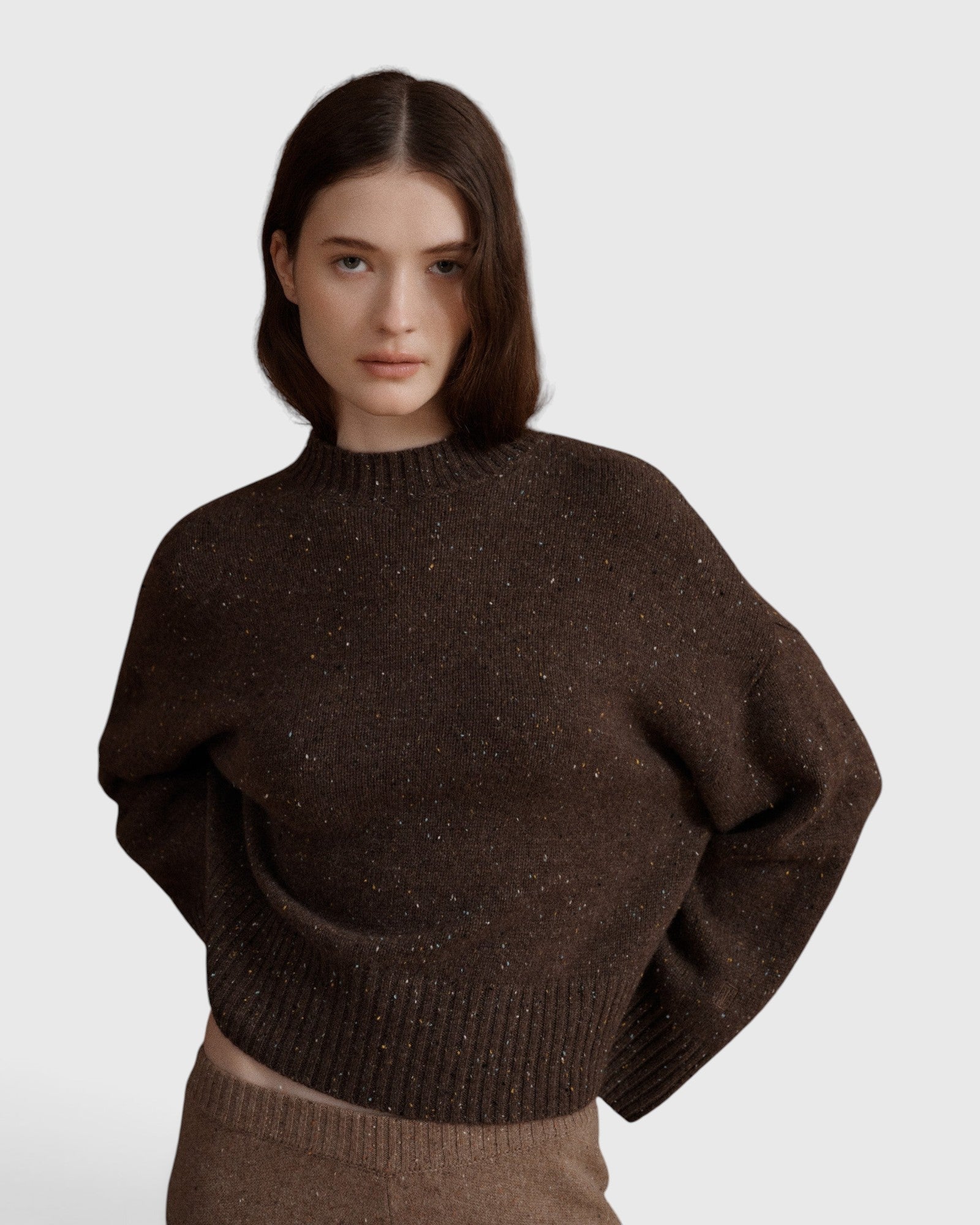 JONES + CO Bettina cashmere sweater in oak brown with mock neck, balloon sleeves, and dropped shoulders on a model