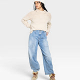 JONES + CO oat-colored turtleneck sweater with chunky rib details on the shoulders and cuffs, made from baby alpaca and cotton yarn.