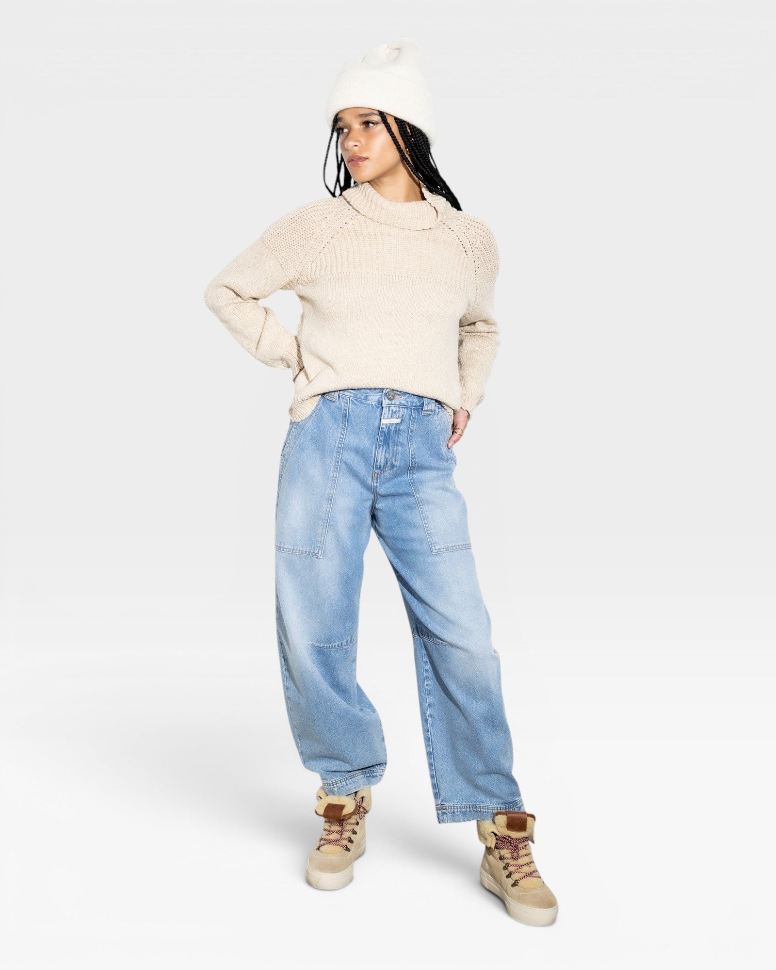 JONES + CO oat-colored turtleneck sweater with chunky rib details on the shoulders and cuffs, made from baby alpaca and cotton yarn.