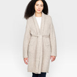 JONES + CO oatmeal alpaca wool blend sweater coat with belt and pockets, worn by a woman with curly hair.