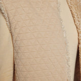 JONES + CO oatmeal reversible vest featuring a quilted texture on one side and plush faux fur trim detail.