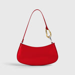 JONES + CO Ollie Bag in polished cherry-red leather with a crescent shape and gold and silver hardware strap detail.