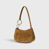 JONES + CO Ollie Bag in cigar brown suede with a crescent silhouette and mixed gold and silver link strap detail.