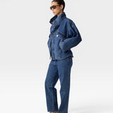 JONES + CO Oversized Augie dark denim jacket with stand collar and asymmetric snap closure on a model.