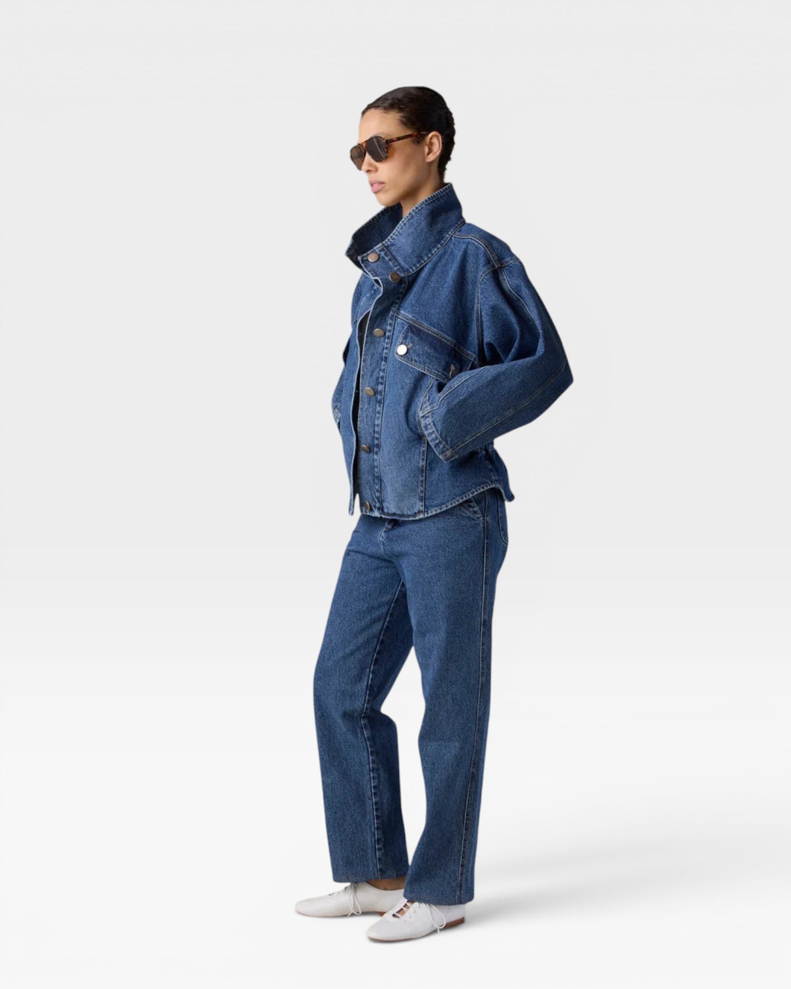 JONES + CO Oversized Augie dark denim jacket with stand collar and asymmetric snap closure on a model.
