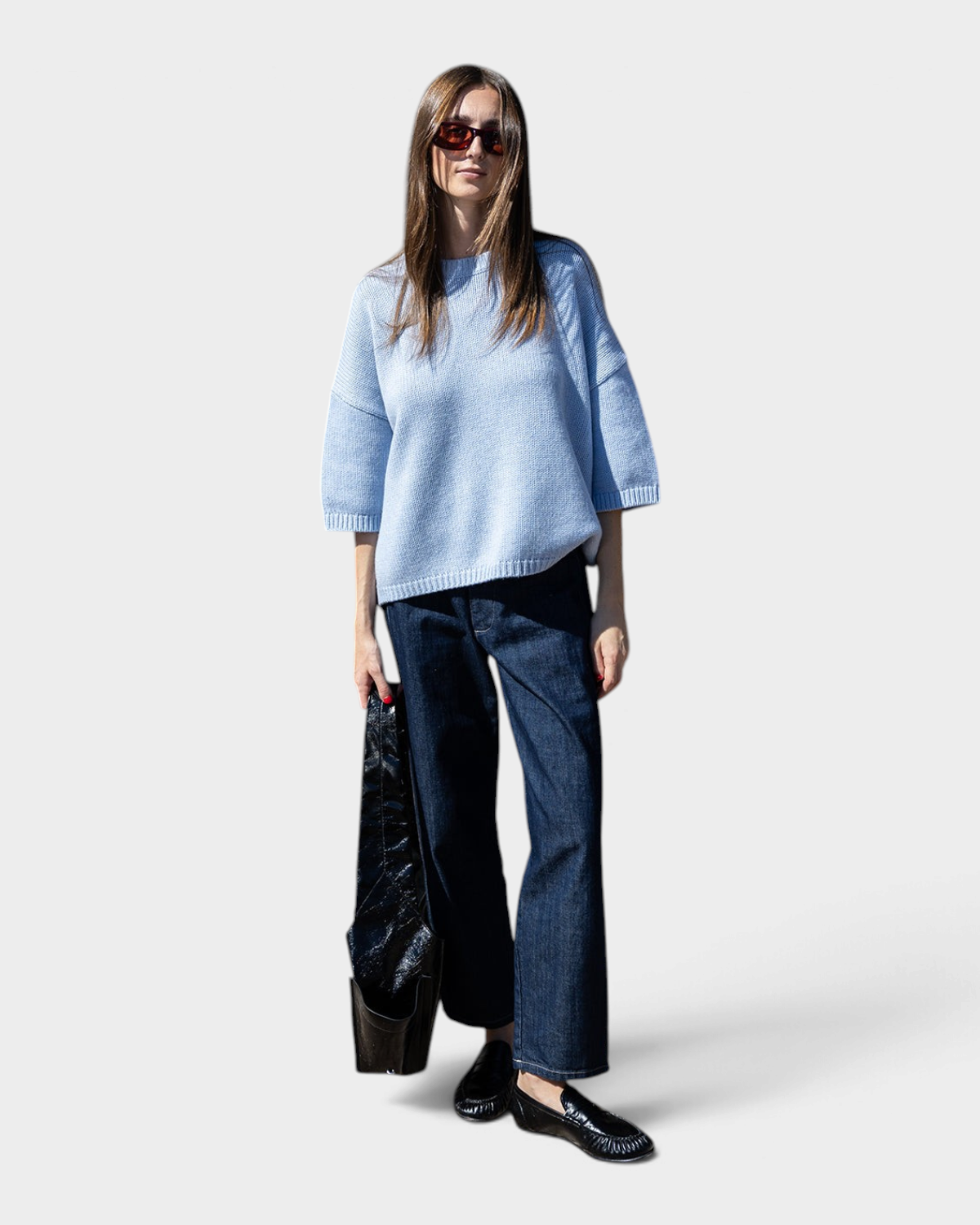JONES + CO oversized heathered blue short sleeve sweater with dropped shoulders worn by a woman with dark jeans