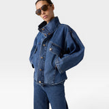JONES + CO dark denim oversized jacket with stand collar, asymmetric snap closure, and flap pockets.