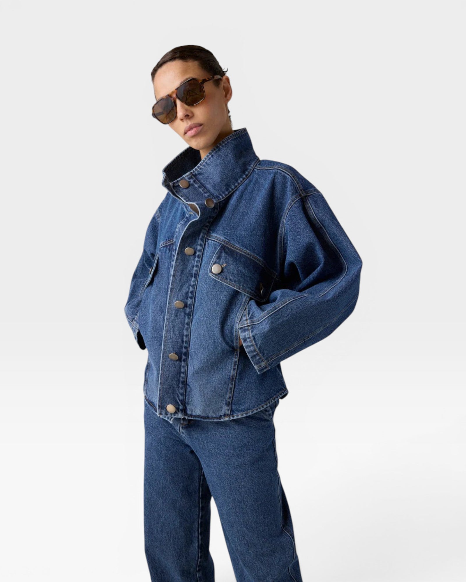 JONES + CO dark denim oversized jacket with stand collar, asymmetric snap closure, and flap pockets.