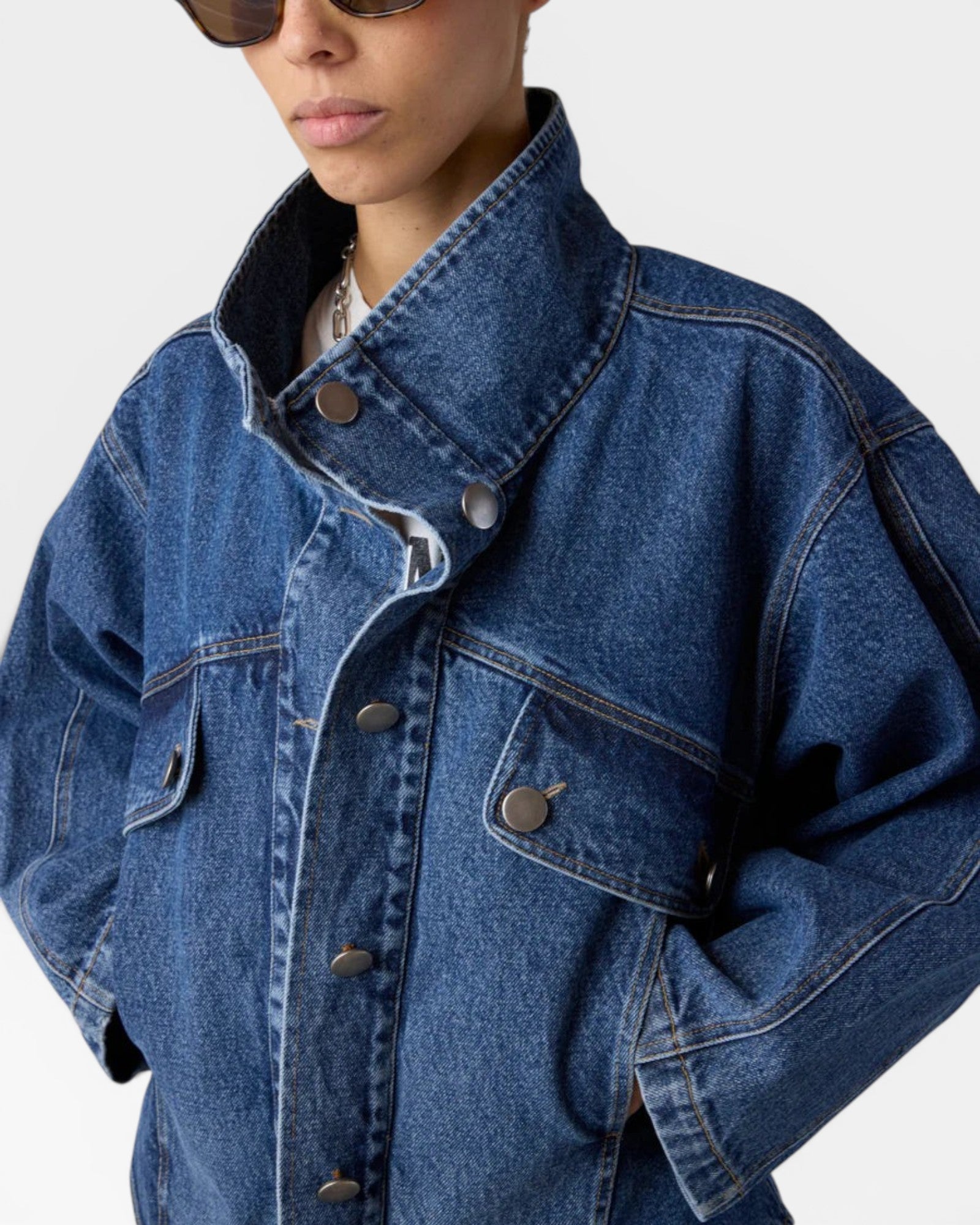 JONES + CO dark blue washed cotton denim oversized jacket with stand collar and asymmetric snap closure.
