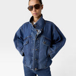 JONES + CO dark denim oversized jacket with stand collar, asymmetric snap closure, and flap pockets.