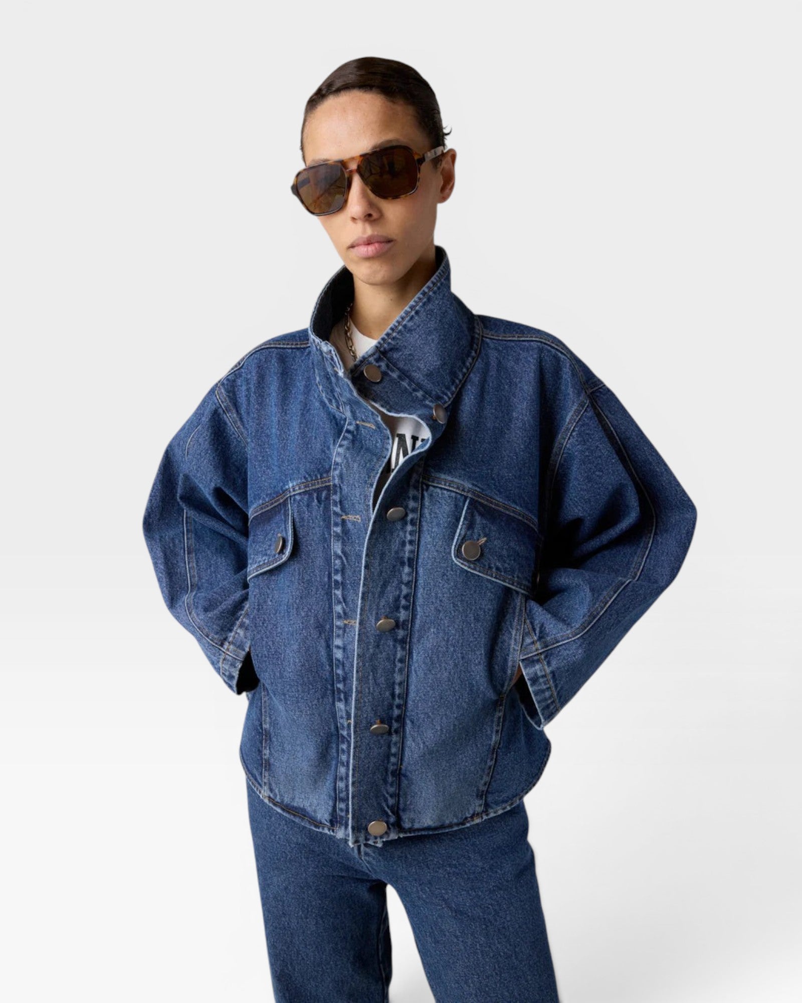 JONES + CO dark denim oversized jacket with stand collar, asymmetric snap closure, and flap pockets.
