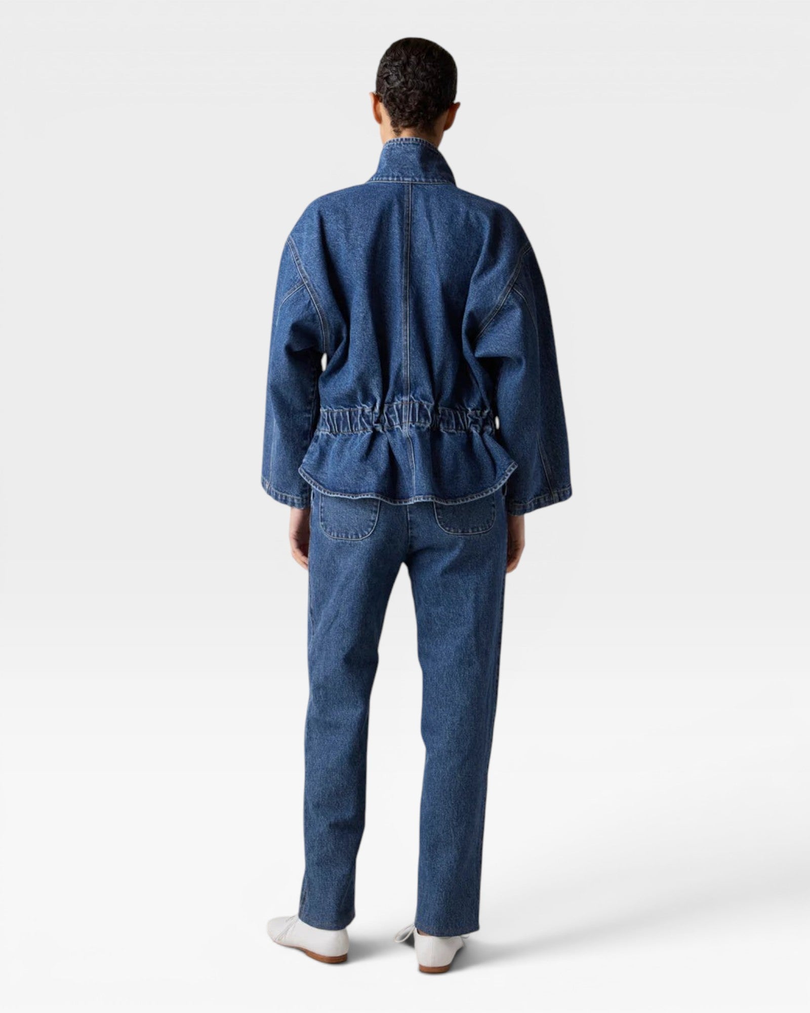 JONES + CO dark denim oversized jacket with elasticized back and stand collar, worn by a model.