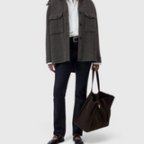 JONES + CO oversized juniper green wool-blend shacket with a checked pattern and diagonal breast pockets on a model.