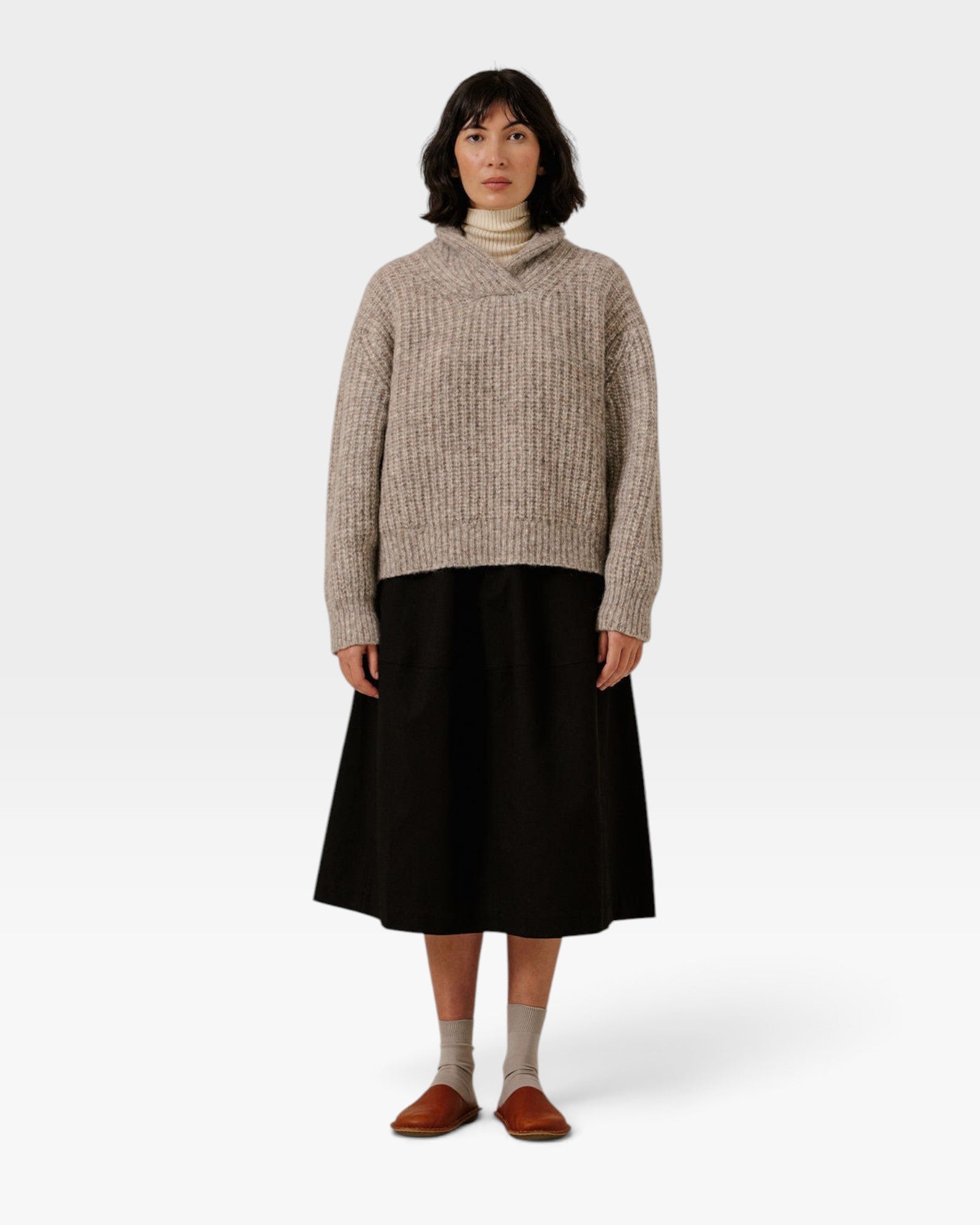 JONES + CO oversized marble shawl-neck sweater in alpaca and Pima cotton blend worn with a black midi skirt