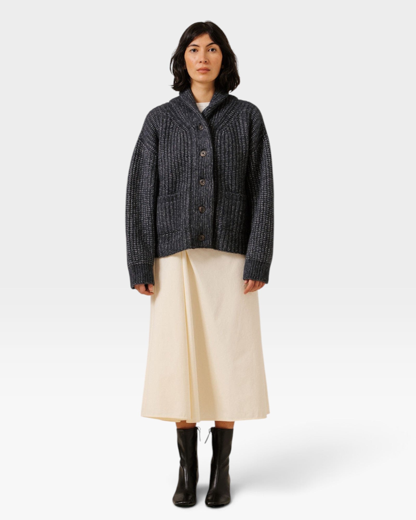 JONES + CO oversized dark navy shawl cardigan in alpaca and Pima cotton blend worn by a model with a cream skirt.