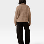 Back view of a model wearing a JONES + CO dark fawn oversized shawl cardigan in an alpaca and Pima cotton blend.