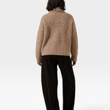 Back view of a model wearing a JONES + CO dark fawn oversized shawl cardigan in an alpaca and Pima cotton blend.
