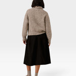 JONES + CO oversized shawl-neck sweater in marble alpaca and Pima cotton blend, worn with a black skirt, back view.