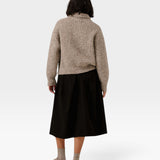 JONES + CO oversized shawl-neck sweater in marble alpaca and Pima cotton blend, worn with a black skirt, back view.