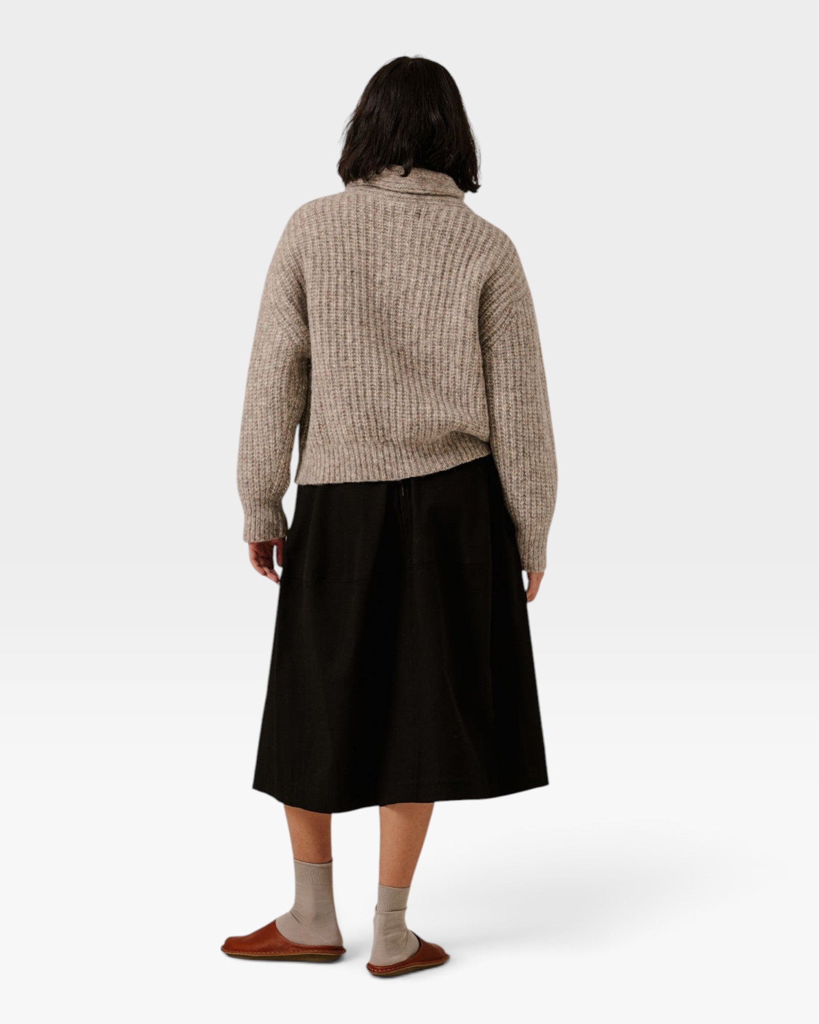 JONES + CO oversized shawl-neck sweater in marble alpaca and Pima cotton blend, worn with a black skirt, back view.