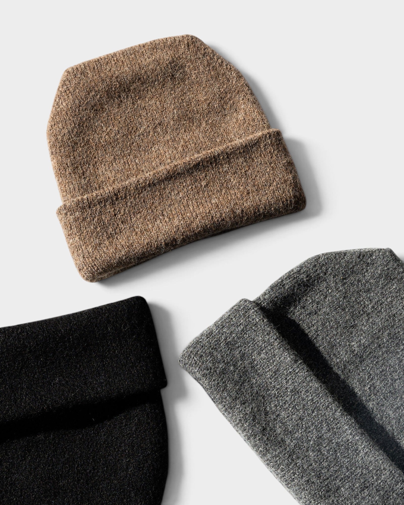 JONES + CO Parker oversized beanies in black, grey, and brown wool-alpaca blend with a cuffed design