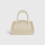 JONES + CO Oyster Mini Duffle in angora pebble grained leather with gold-tone hardware and structured top handles.