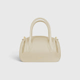 JONES + CO Oyster Mini Duffle in angora pebble grained leather with gold-tone hardware and structured top handles.