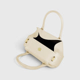 JONES + CO Oyster Mini Duffle in Angora pebble grained Italian leather with gold-tone hardware and top handles.