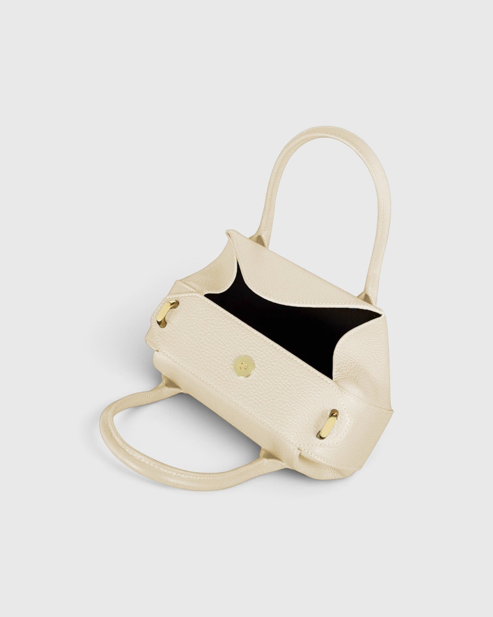 JONES + CO Oyster Mini Duffle in Angora pebble grained Italian leather with gold-tone hardware and top handles.