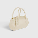 JONES + CO Oyster Mini Duffle in Angora pebble grained Italian leather with gold-tone hardware and top handles.