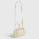 JONES + CO Oyster Mini Duffle in Angora pebble grained Italian leather with gold hardware and crossbody strap.