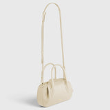 JONES + CO Oyster Mini Duffle in Angora pebble grained Italian leather with gold hardware and crossbody strap.