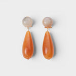 JONES + CO Pamploma sculptural acrylic earrings with cream spherical studs and orange tear-shaped drops.