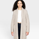 JONES + CO Parker Sweater Coat in oatmeal, a cozy alpaca wool blend with dropped shoulders and front pockets.
