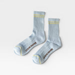 JONES + CO Boyfriend Socks in pastel sky blue with yellow double stripes, ribbed texture, and arch support.